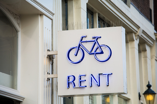 Rent bicycle blue neon sign in Amsterdam city