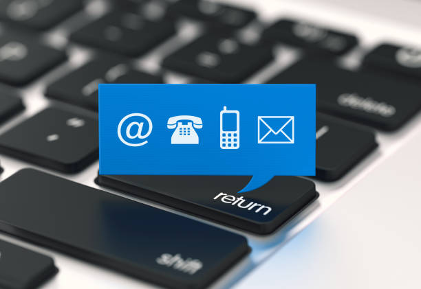 istock Blue Speech Bubble With Contact Us Symbols Over A Laptop Keyboard Background 959588824