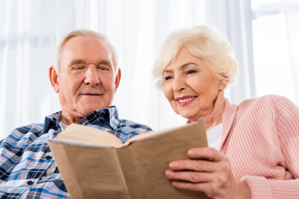 istock happy senior couple reading book together 959591076