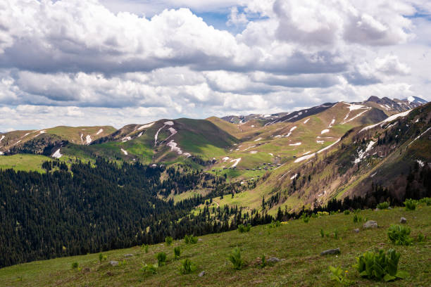 istock Mountain valley lies surrounded by green hills 959594238