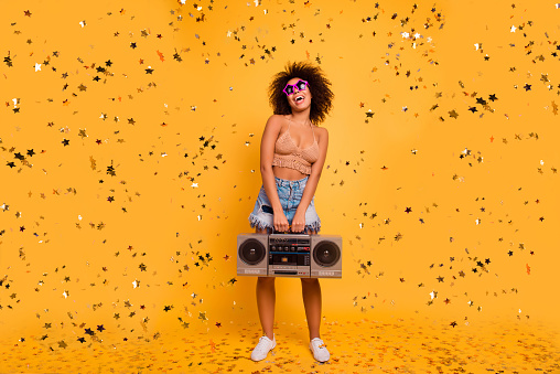 Let the party start! Full-length of playful crazy funny excited cheerful with bronze skin patrybotch is holding retro old-fashioned boombox, organizing a party, isolated on yellow background