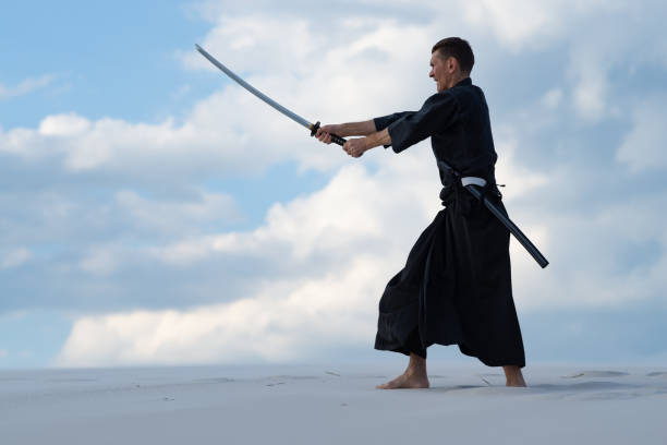 istock Man is practicing Japanese martial arts in the desert 959598718