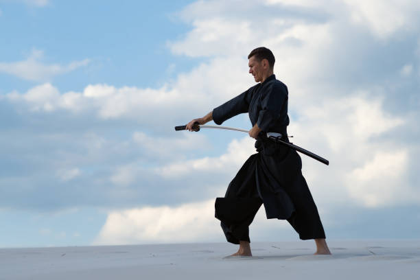 istock Focused man practicing Japanese martial art in desert 959598766