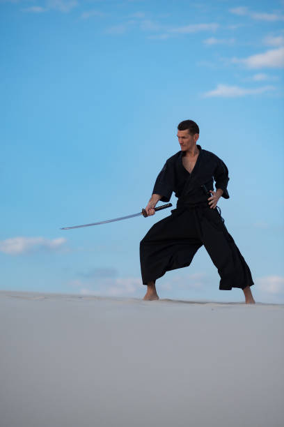istock Man is training Japanese martial arts in desert 959598946