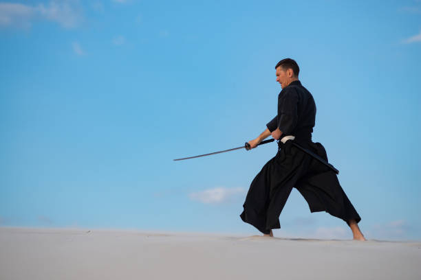 istock Man is training Japanese martial arts in desert 959598980
