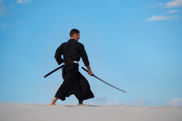 istock Man is training Japanese martial arts in desert 959598998