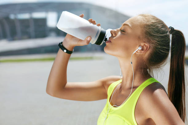 istock Drink Water From Bottle. Woman Drinking After Running 959603892