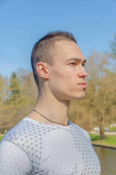 istock a man in a white sports uniform, warming up 959605128