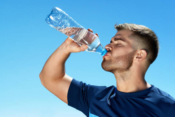 istock Man Drinking Water After Running. Portrait. 959607778