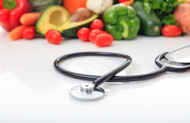 istock Variety of fresh vegetables and stethoscope on white background 959608080