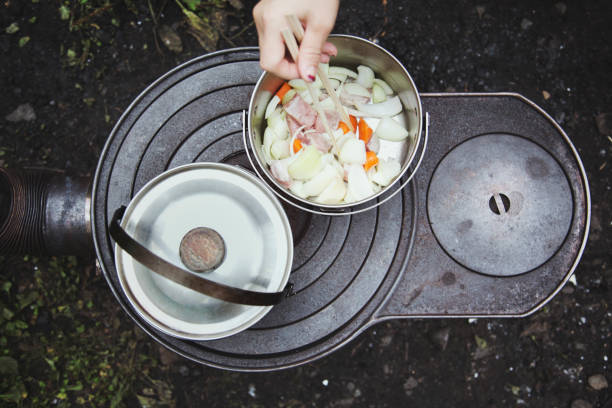 A bird eye's view of hand of woman cooking outside.