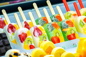 arranged freshy fruity; kiwi, strawberry, berry, dragon fruit, papaya, mango, mint, chocolate, milk, orange, pineapple ice-cream stick, frozen in frozen machine.