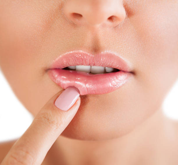 istock Woman lips. Woman touch her lips. 959613618