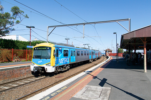 Melbourne, Australia: April 03, 2018: A train arrives in Brighton Beach railway station which is located on the Sandringham line in Victoria, Australia and serves the south-eastern Melbourne suburb of Brighton. It opened in 1861.
