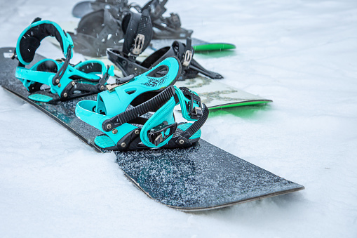 Side view of snowboard on the snow background