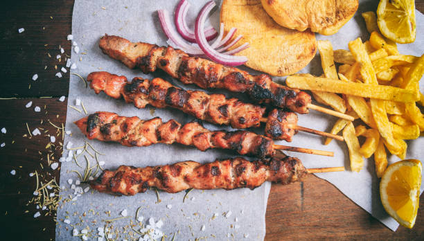 istock Grilled meat skewers on a wooden background 959618326