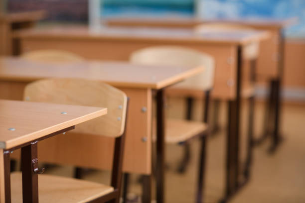 istock School classroom in blur background without young student; Blurry view of class room no kid or teacher with chairs and tables in campus. 959622448