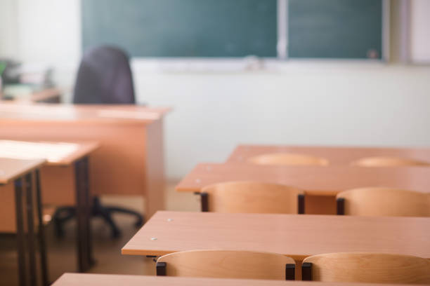 istock School classroom in blur background without young student; Blurry view of class room no kid or teacher with chairs and tables in campus. 959622464
