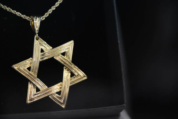 istock Star of David pendant on a black background 959625664