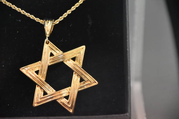 istock Star of David pendant on a black background 959625866