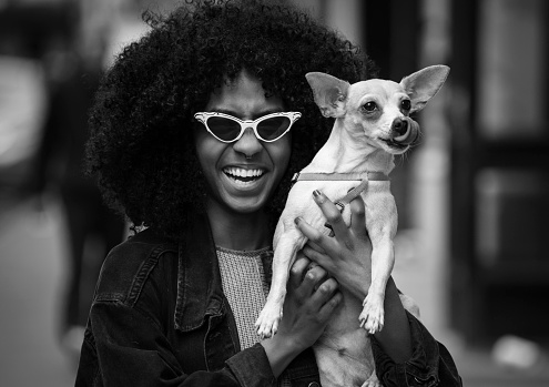 Young woman with her dog on the street in New York, USA