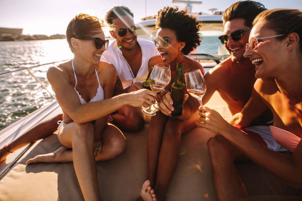 istock Multiracial friends toasting drinks on the yacht deck 959629916