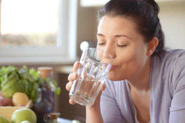 istock woman cooking in the kitchen ( drinking) 959633026