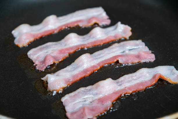 istock slices of fresh fried bacon in a pan 959635842