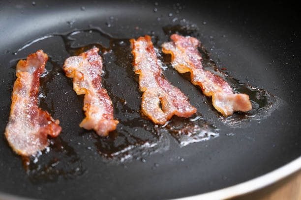 istock slices of fresh fried bacon in a pan 959636034