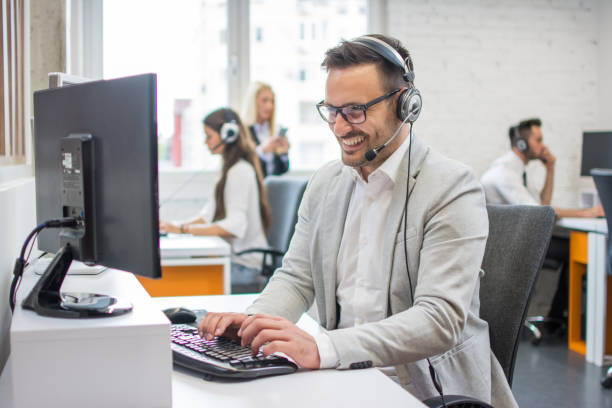 istock Smiling customer service executive with headset working in call center. 959638326