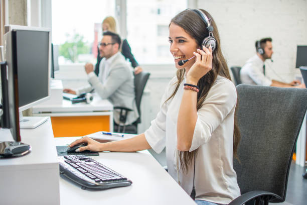 istock Young smiling operator woman agent with headsets working in a call center. 959638328