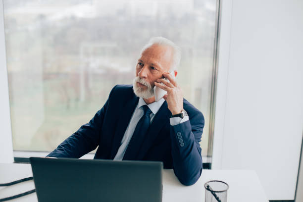 istock Elderly business man using mobile phone at the office 959638542