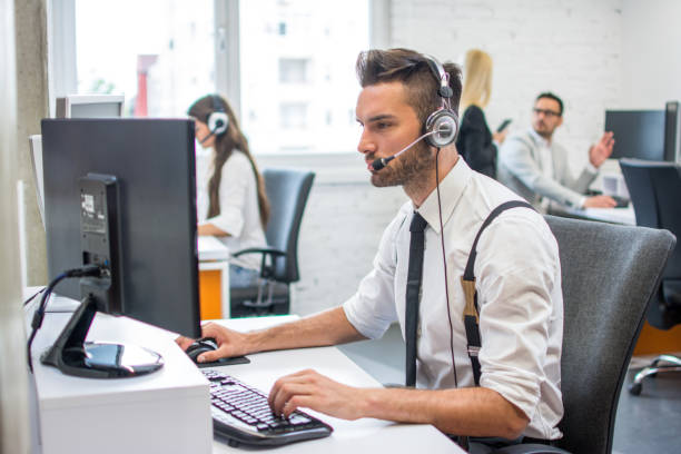 istock Beautiful handsome man with headset working in call center. 959638612