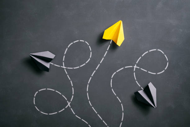 istock Paper airplane on blackboard - Origami Yellow Concept 959639206