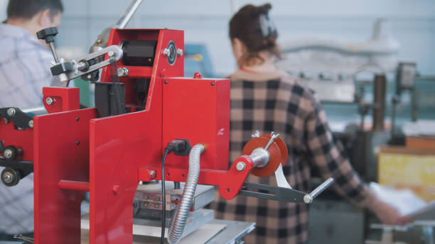 istock Printing press equipment in front of people working in typography 959639444