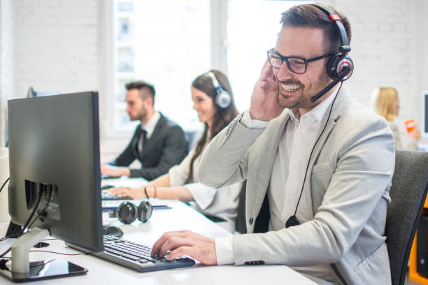 istock Smiling call center worker with headset giving technical support to customers. 959640320
