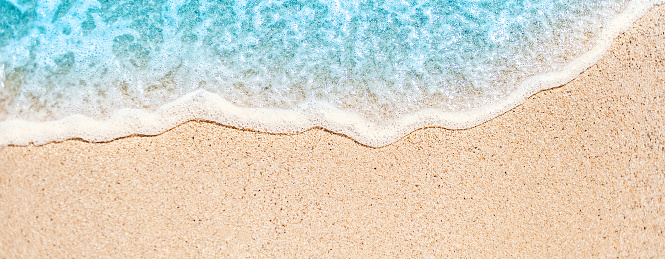 Soft wave of blue ocean on sandy beach with copy space fr text. Summer Background.