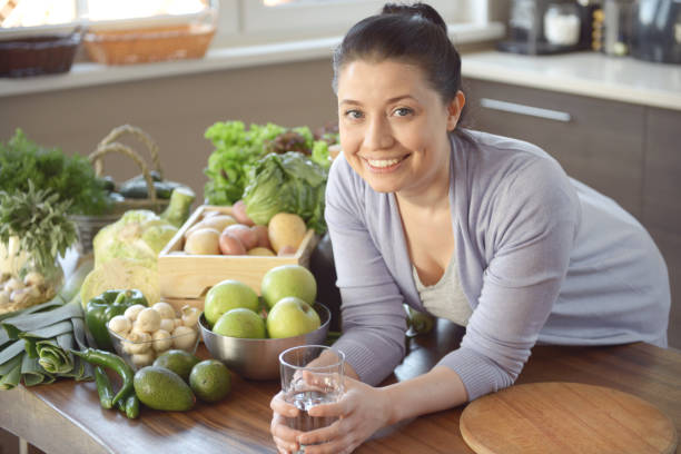 istock woman cooking in the kitchen ( drinking) 959642344