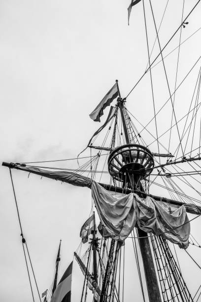 Classic sailing ship mast with sails with clouds in the background on the river IJssel in Kampen.
