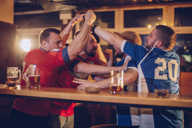istock Group of men fighting in sports pub 959642814