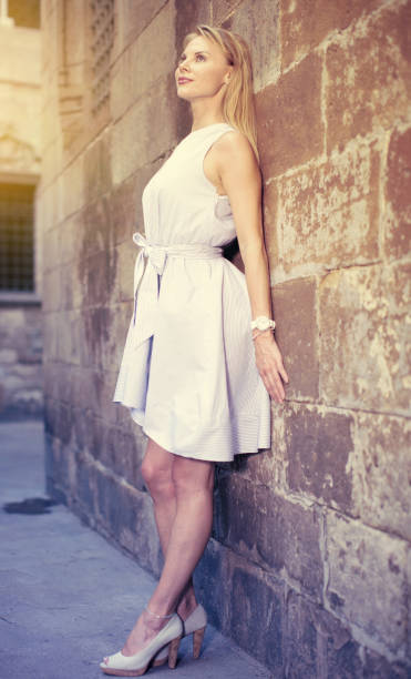 istock smiling woman near the stone wall 959642942