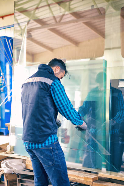 istock Worker handling glass sheet in warehouse 959645660