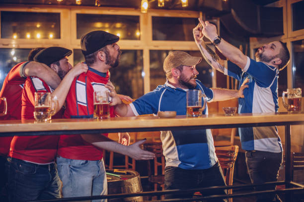 istock Men arguing in sports pub 959645774
