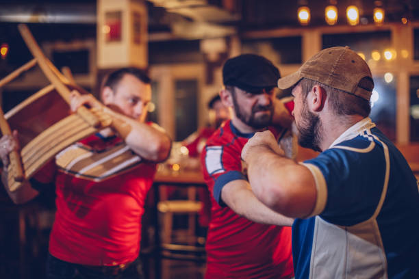 Men arguing in sports bar Group of men fighting in sports bar alcoholism alcohol addiction drunk stock pictures, royalty-free photos & images