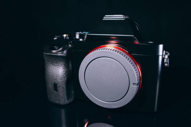 istock Professional modern DSLR camera low key image - Modern DSLR camera with a very wide aperture lens 959651058
