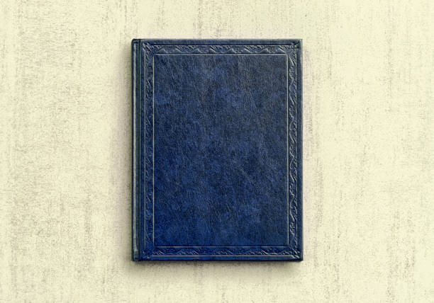 istock mock up book blue color on gray background close-up, top view 959651868
