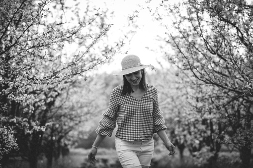 Beautiful woman standing in the orchard