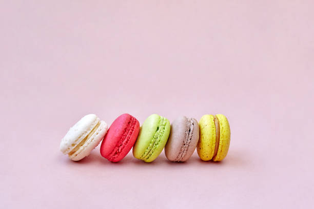istock Colorful macaroons or macarons arrange on the lemonade color background with space for text, isolated 959662230