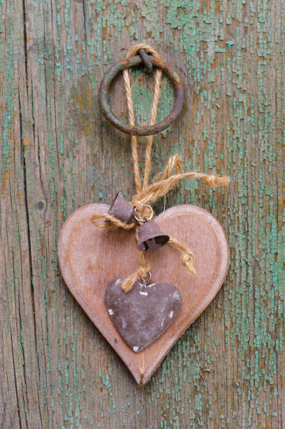 istock wooden heart hanging on plank 959670434