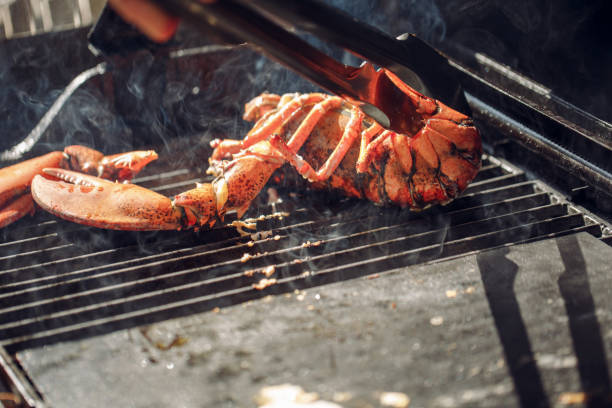 istock Lobster grilled barbecued seafood in BBQ Flames. 959670702